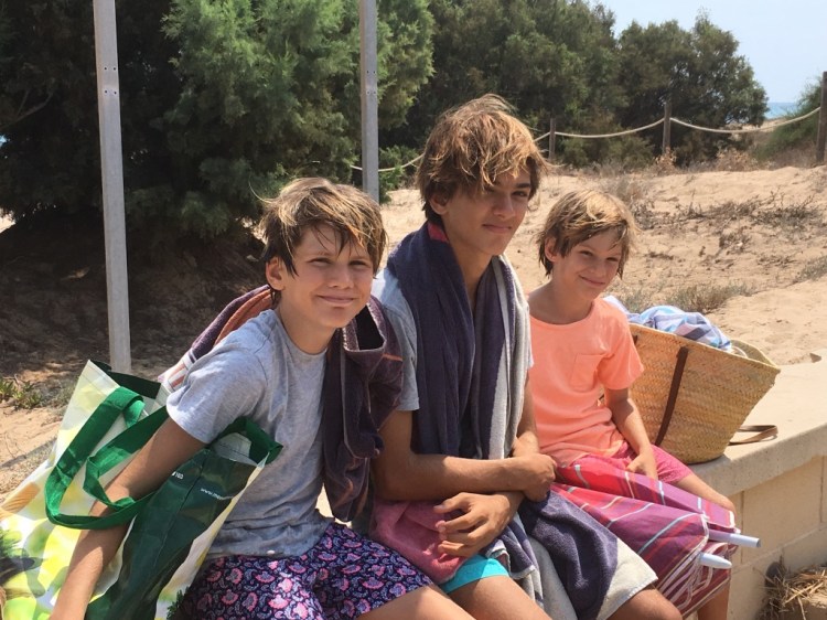 Boys sitting beach Alicante